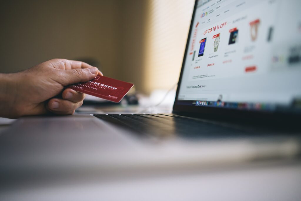 Person using a credit card to make a purchase on Ebay