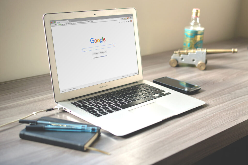 Google homepage on laptop on table