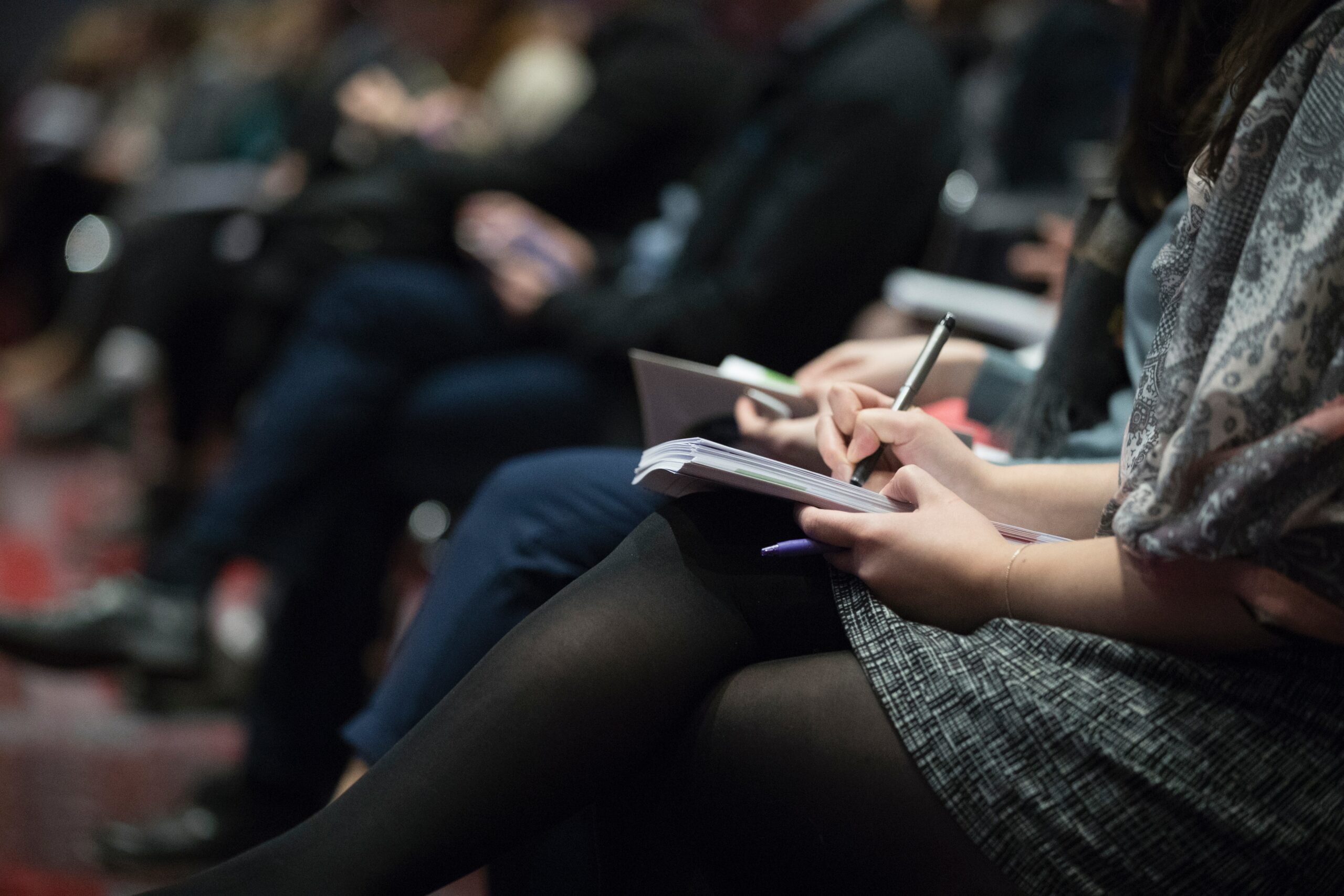 Attendees taking notes at the Shopify Unite event